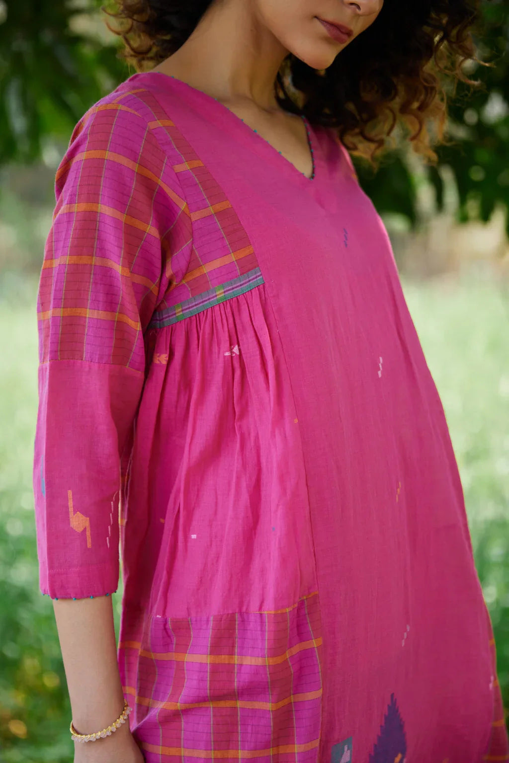 Sarron Amoli Dress, pink cotton Jamdani maxi dress with solid and checked panels and waist smocking.