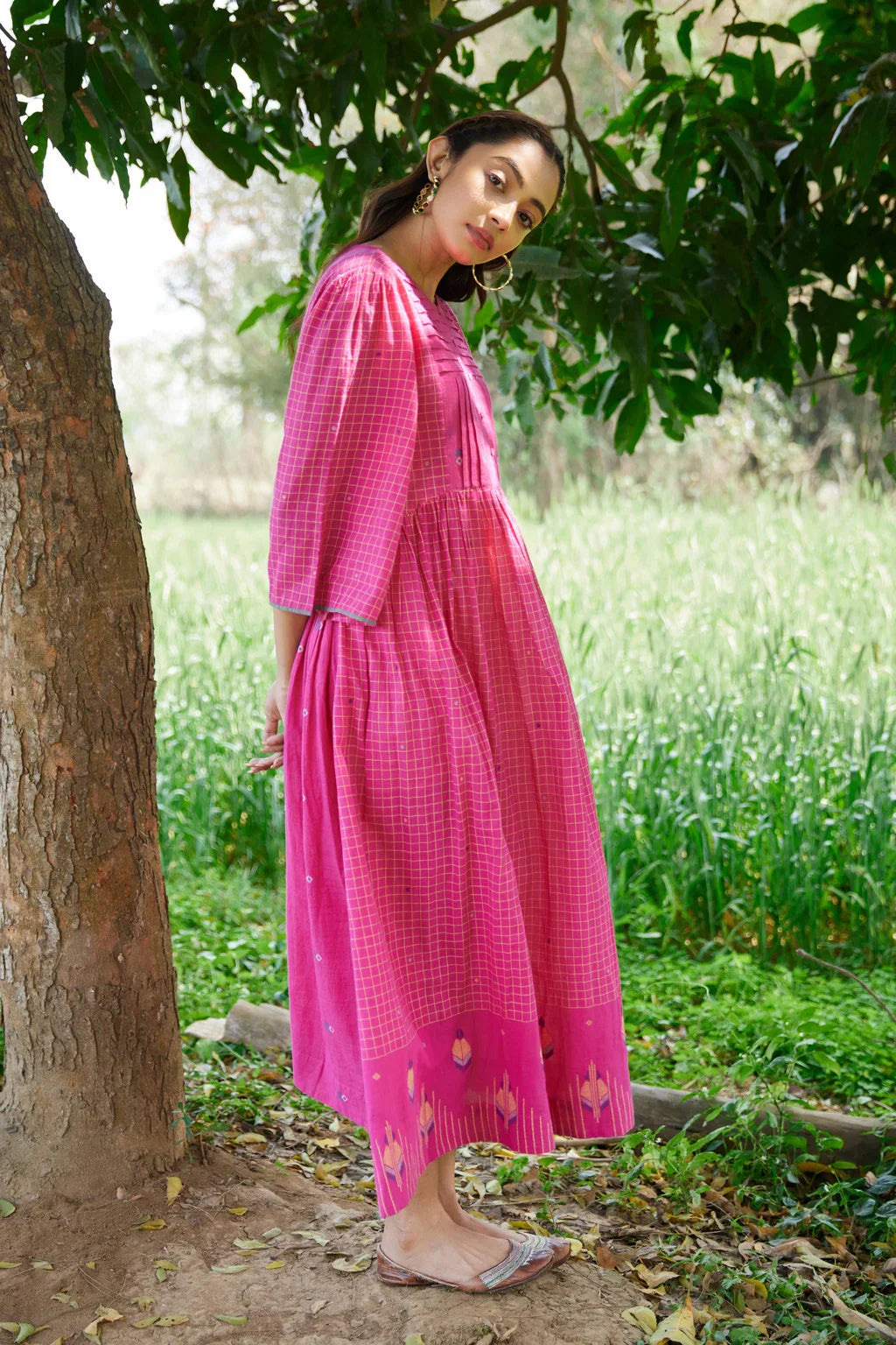 Sarron Anjoli Dress, pink cotton Jamdani dress with a checked weave, pintucks and fabric buttons.