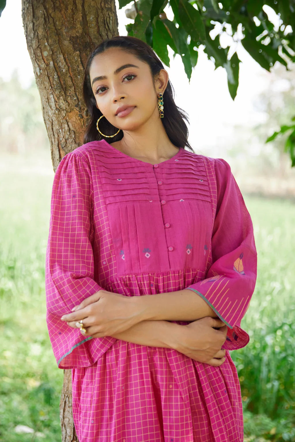 Sarron Anjoli Dress, pink cotton Jamdani dress with a checked weave, pintucks and fabric buttons.