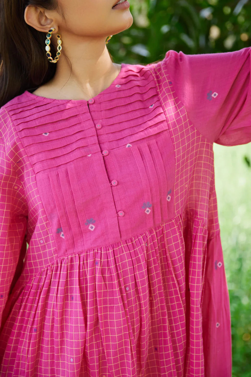 Sarron Anjoli Dress, pink cotton Jamdani dress with a checked weave, pintucks and fabric buttons.