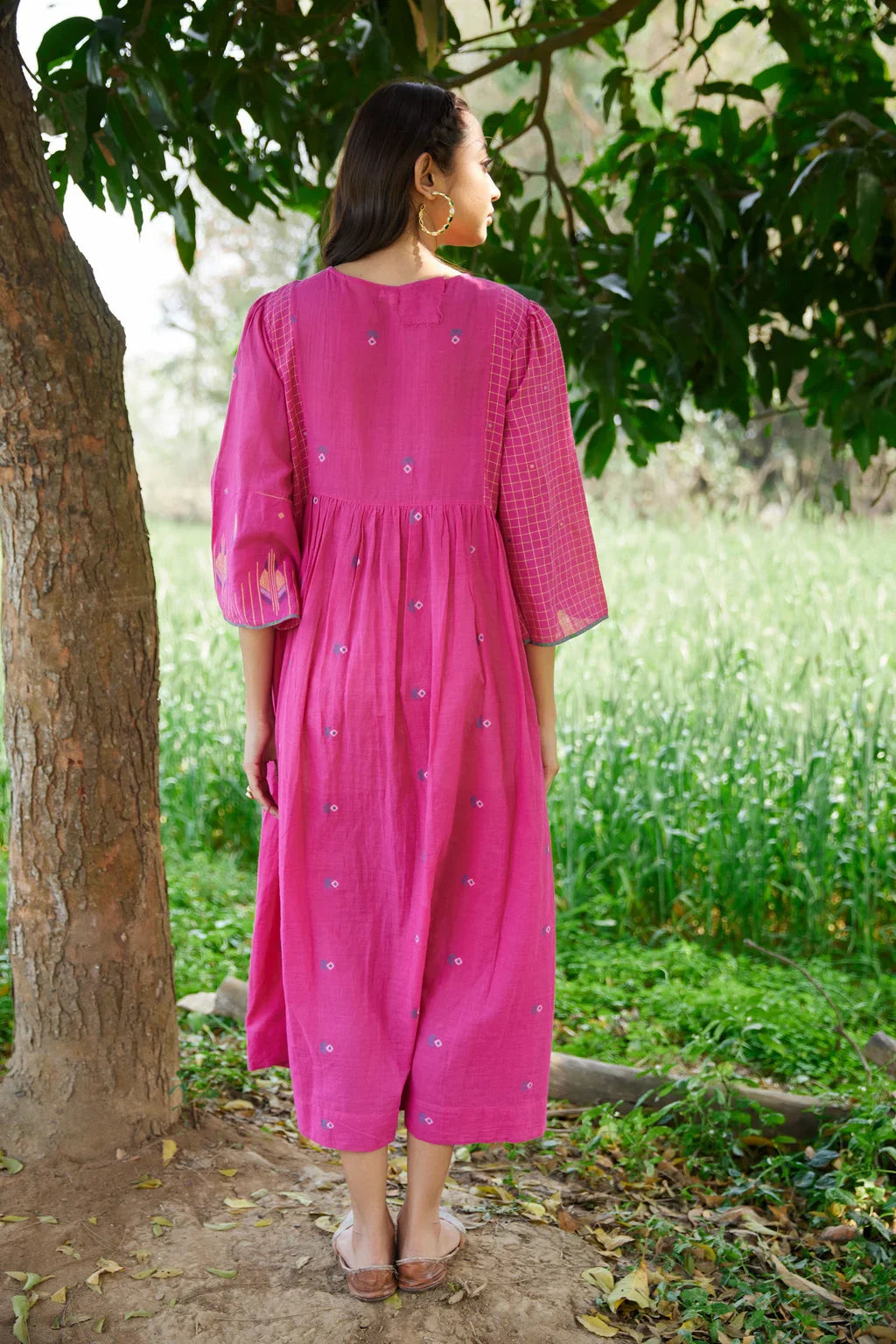 Sarron Anjoli Dress, pink cotton Jamdani dress with a checked weave, pintucks and fabric buttons.