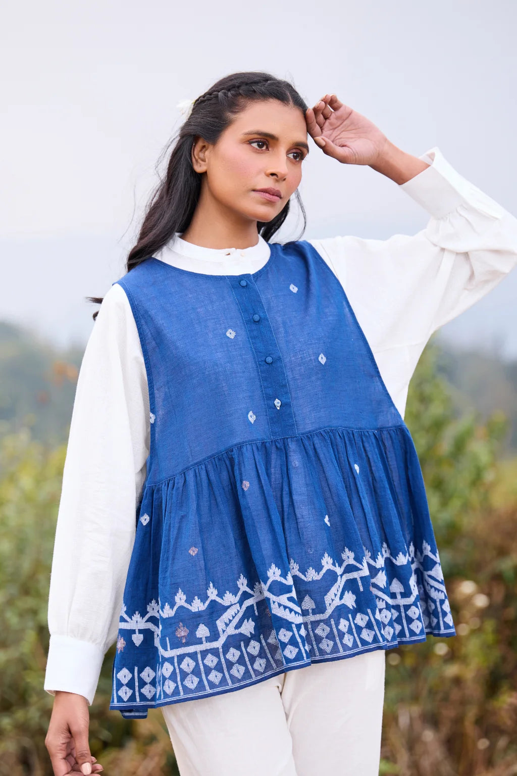 Sarron Aparajita Top, sleeveless blue cotton Jamdani top with tie-ups and a handcrafted bird tassel.