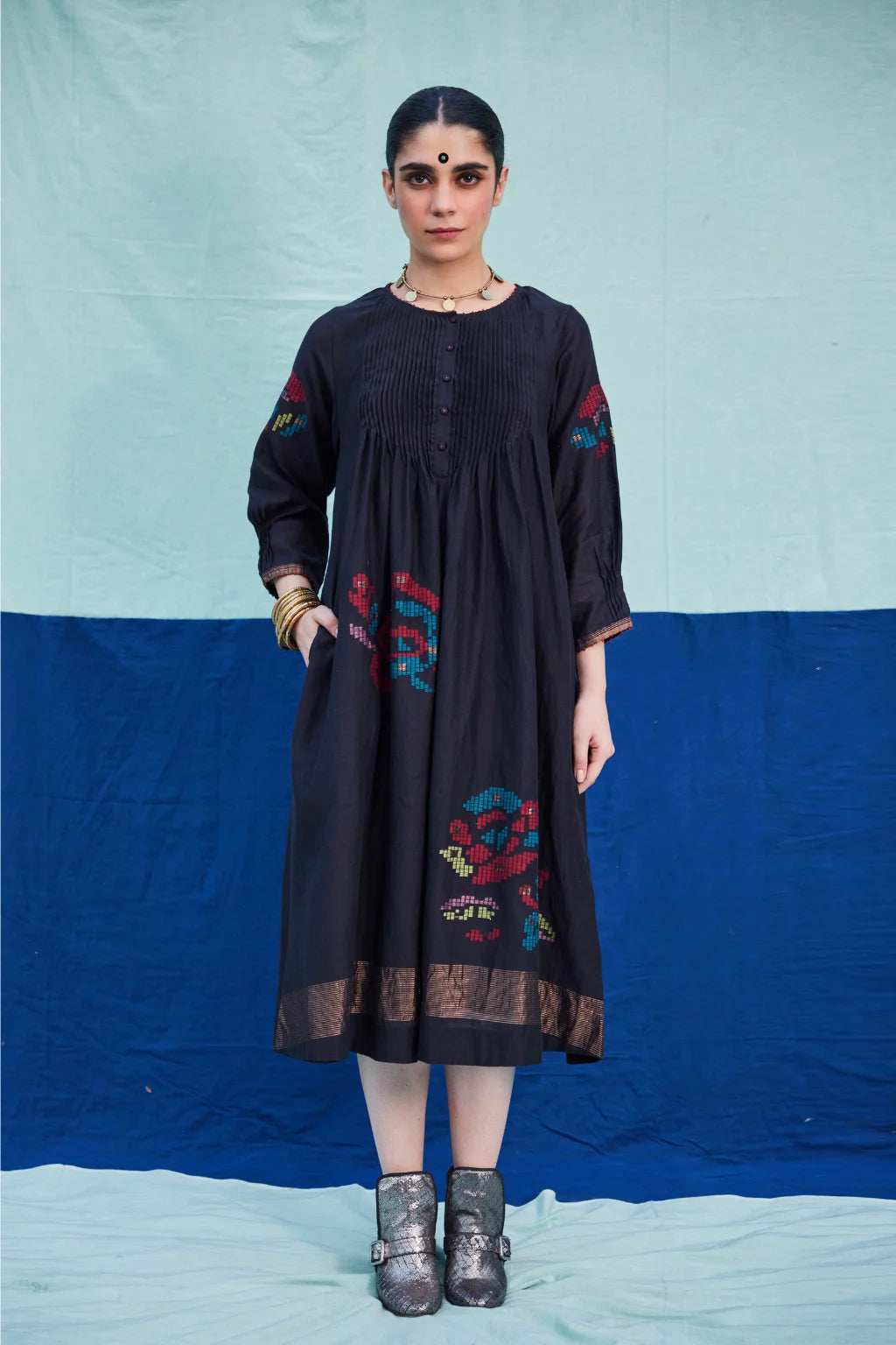 Sarron Bindu Dress, black silk-cotton Jamdani dress with large multicoloured graph butas and pintucks.
