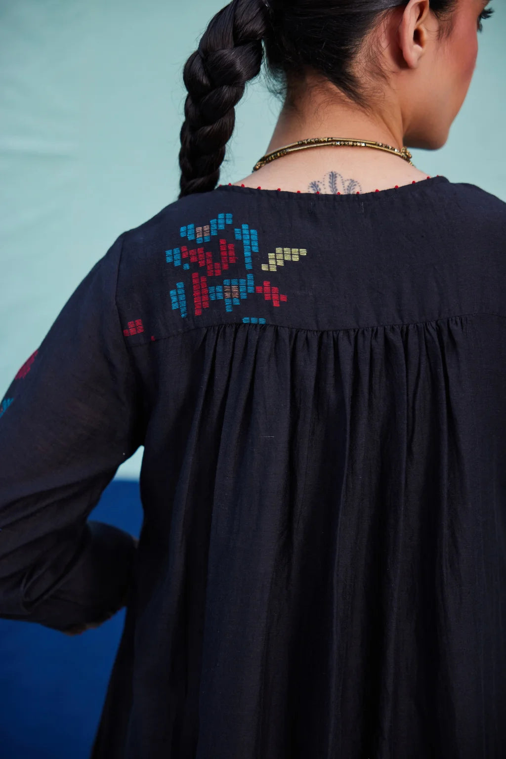 Sarron Bindu Dress, black silk-cotton Jamdani dress with large multicoloured graph butas and pintucks.