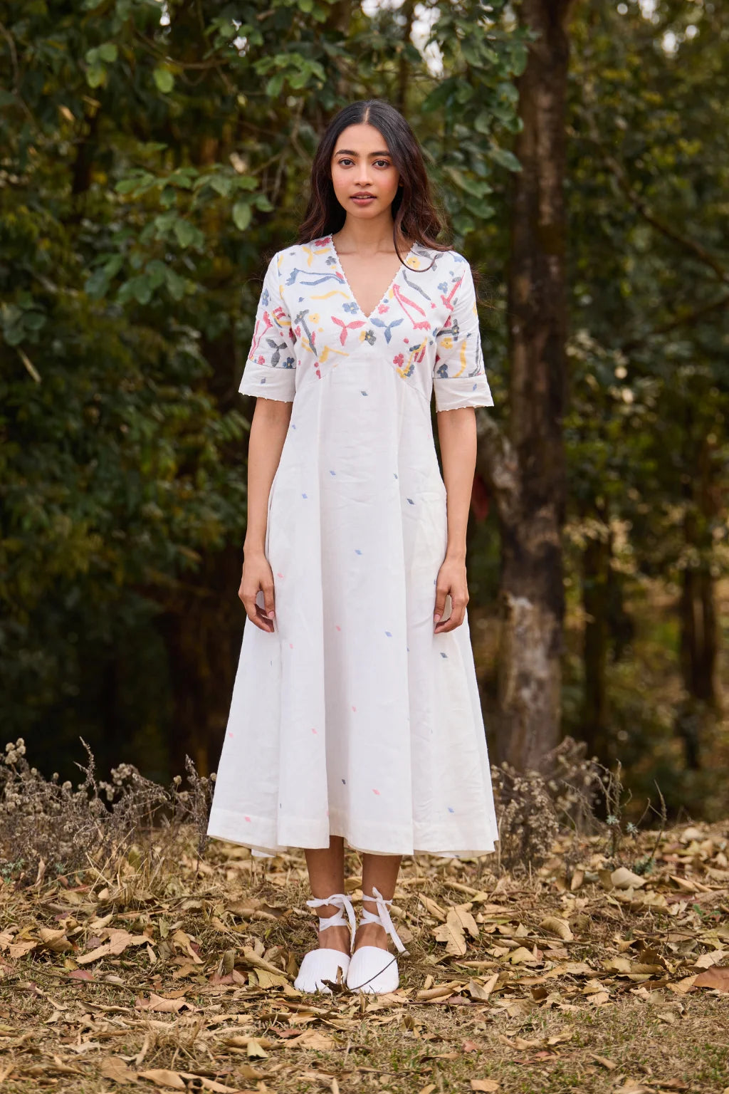 Sarron Giribala Dress, white cotton Jamdani A-line dress with handwoven floral motifs and beaded neckline.