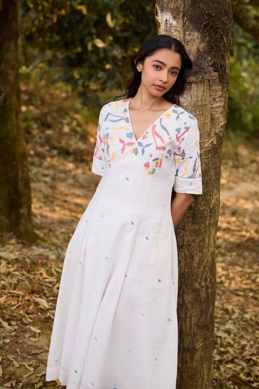 Sarron Giribala Dress, white cotton Jamdani A-line dress with handwoven floral motifs and beaded neckline.