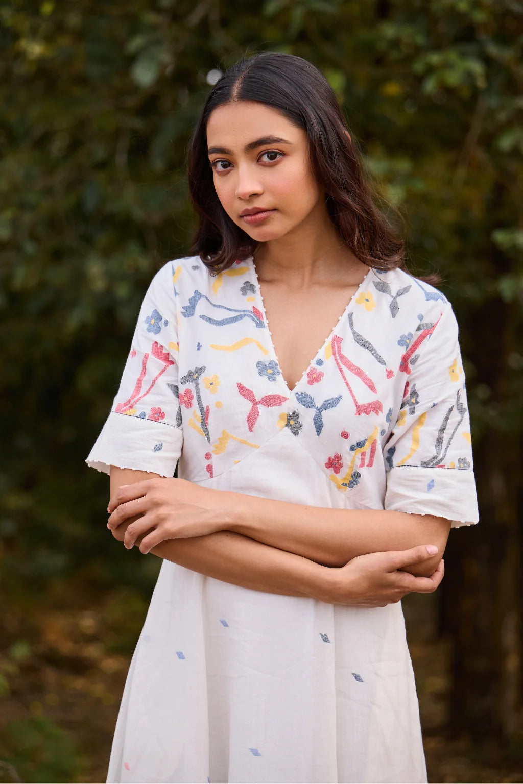 Sarron Giribala Dress, white cotton Jamdani A-line dress with handwoven floral motifs and beaded neckline.