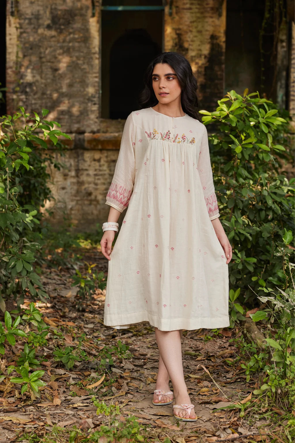 Sarron Khanak Dress, off-white cotton Jamdani dress with red and copper zari motifs and floral hand embroidery.