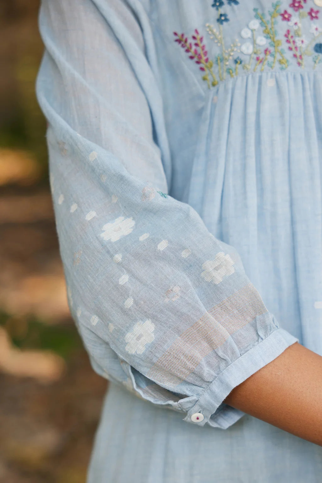 Sarron Kusum Dress, light blue cotton Jamdani dress with white and gold zari floral motifs.