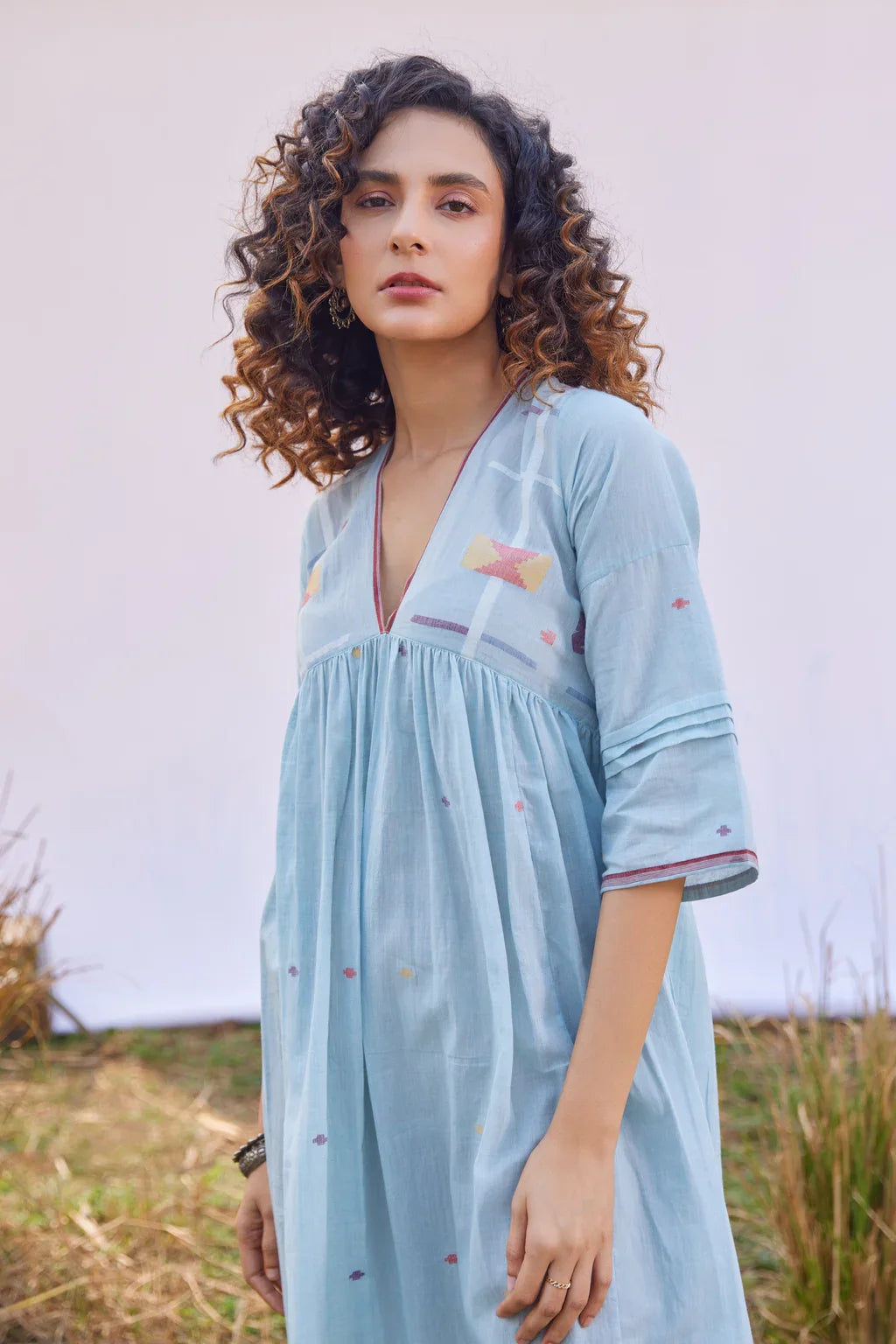 Sarron Meghna Dress, light indigo cotton Jamdani dress with a V-neckline and handwoven Jamdani motifs.