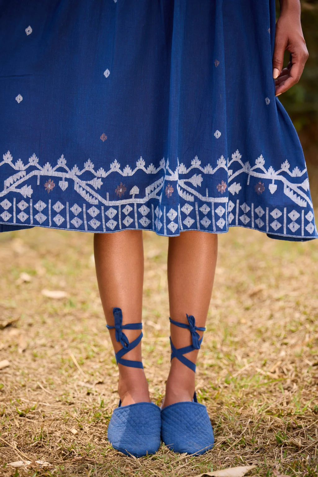 Sarron Neelpadma Dress, deep indigo cotton Jamdani flare dress with geometric hem motifs and pintucks.