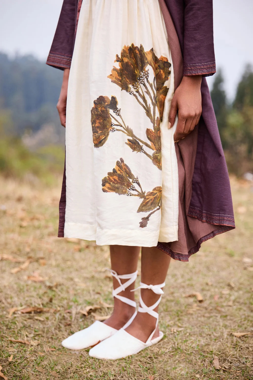 Sarron Parijat Set, ivory silk dress with hand-painted motifs and a plum silk-cotton Jamdani overlay.