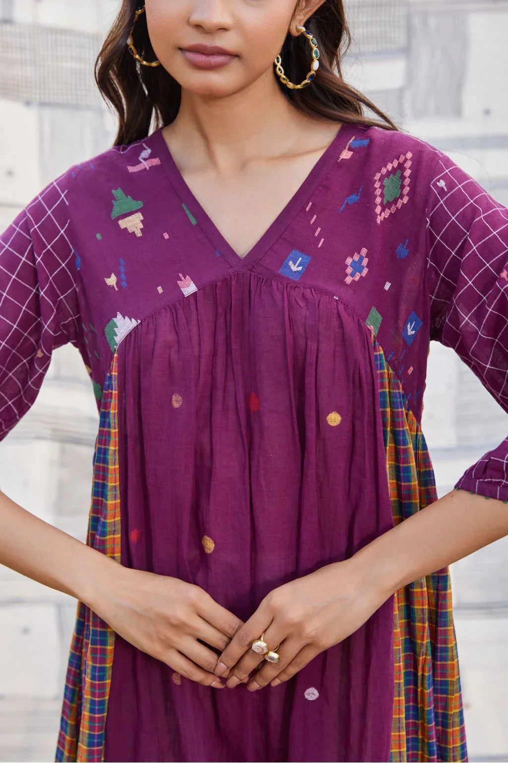 Sarron Sana Dress, red cotton Jamdani dress with multicoloured stripe panels and a V-neckline.