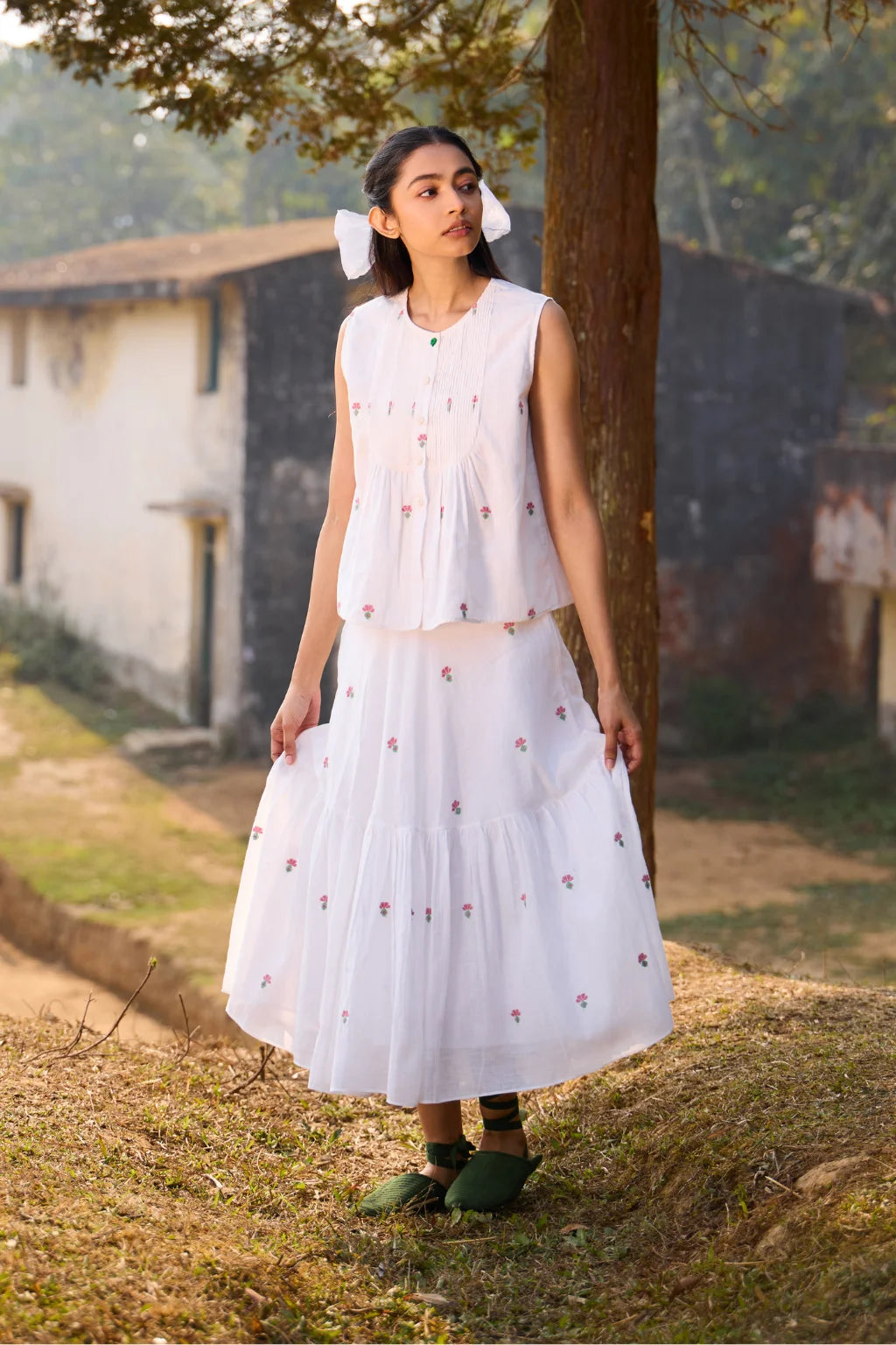 Sarron Shiuli Top, sleeveless white cotton Jamdani top with handwoven floral motifs and front pintucks.