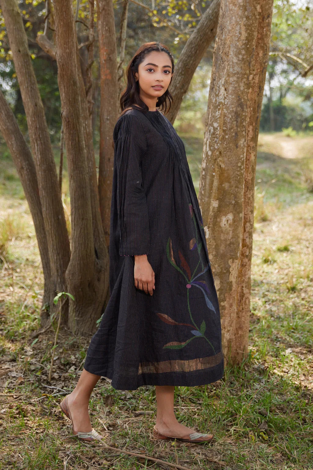 Sarron Sumi Dress, black silk-cotton Jamdani dress with golden stripes and scattered floral motifs.