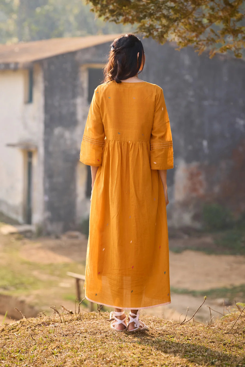 Sarron Ushnota Dress, mustard yellow cotton Jamdani V-neck dress with a geometric yoke motif and Kantha-worked sleeves.