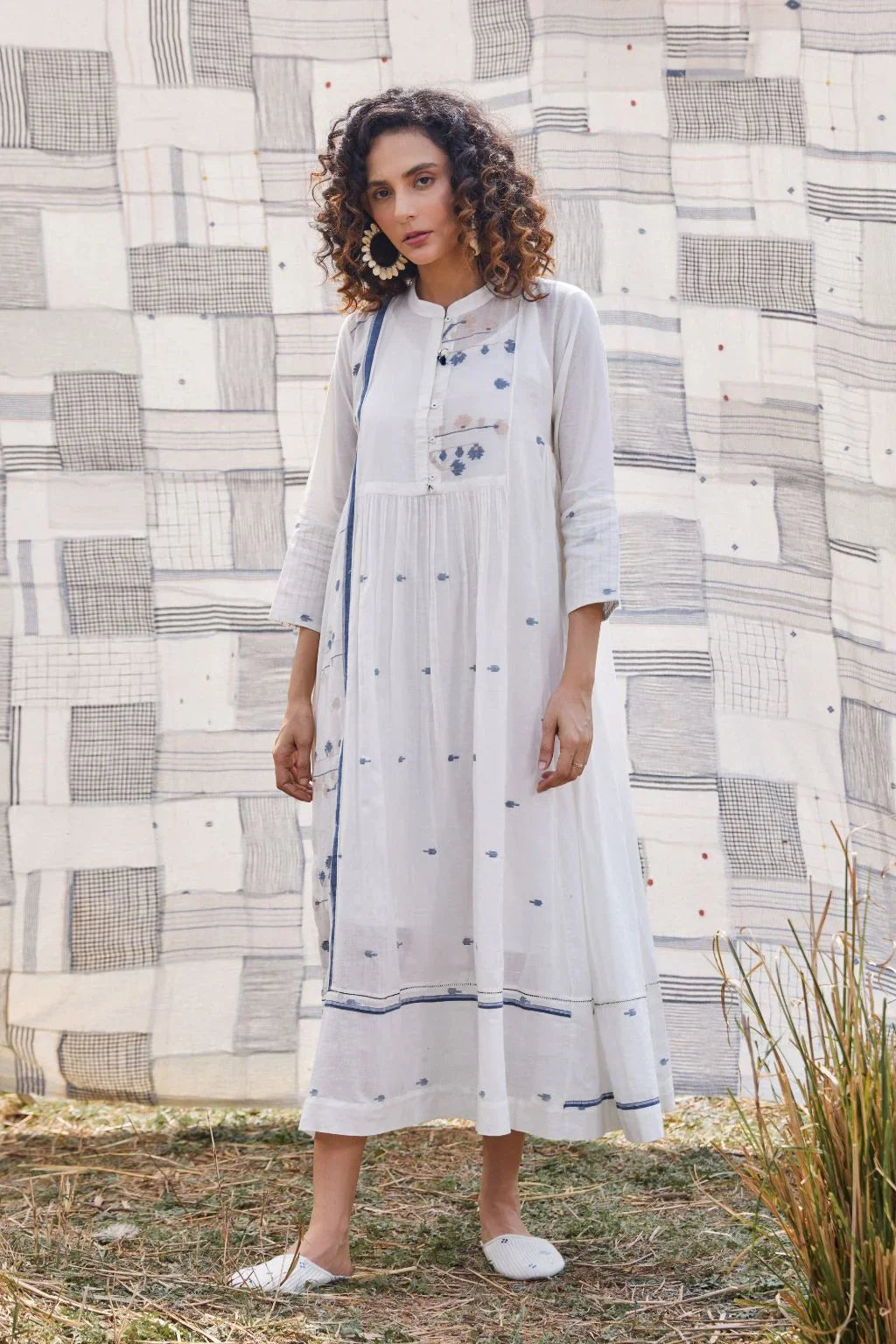Sarron Yashvi Dress, white cotton Jamdani dress with handwoven blue motifs and a mandarin collar.