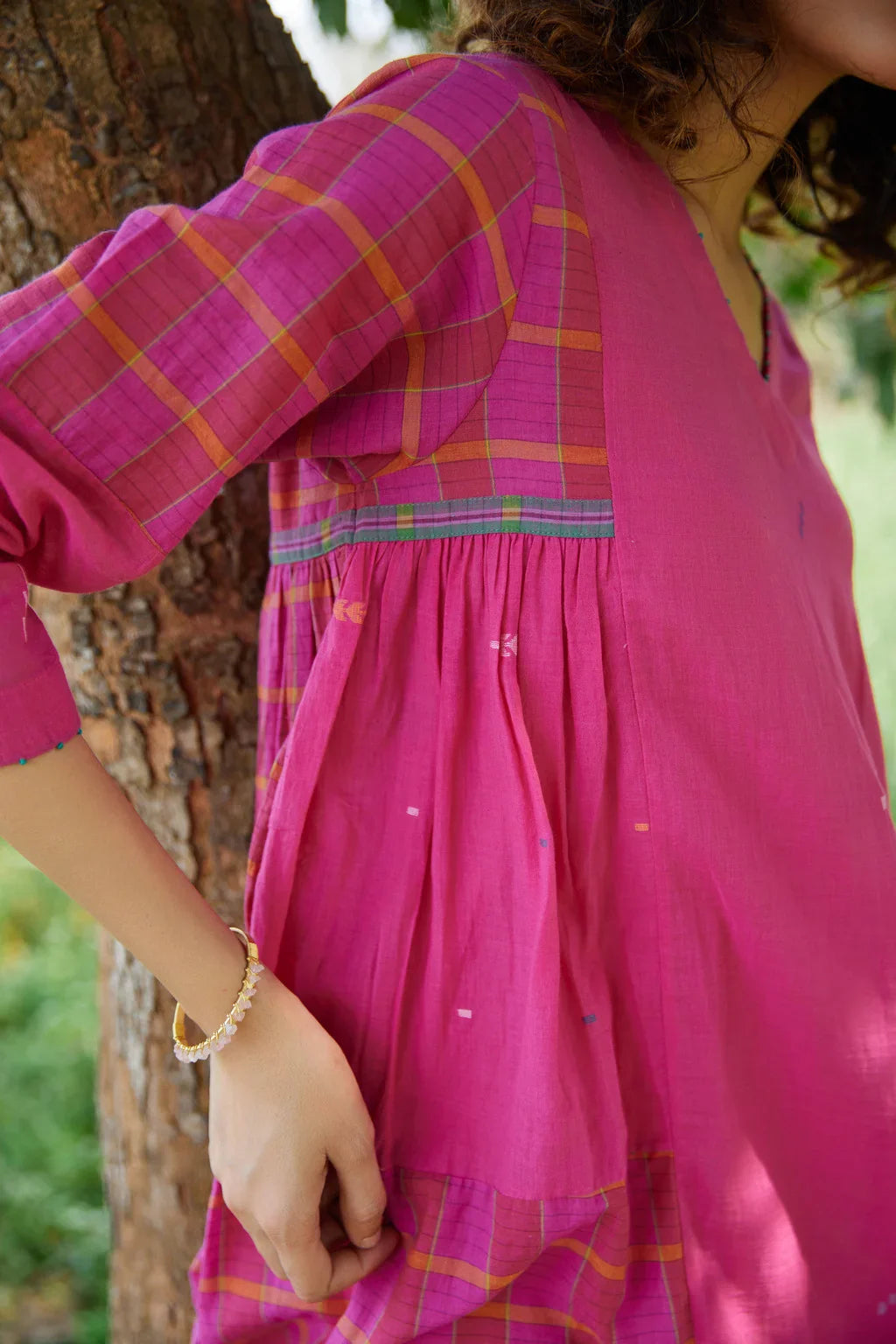 Sarron Amoli Dress, pink cotton Jamdani maxi dress with solid and checked panels and waist smocking.