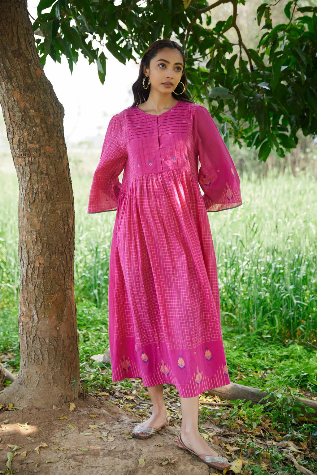 Sarron Anjoli Dress, pink cotton Jamdani dress with a checked weave, pintucks and fabric buttons.