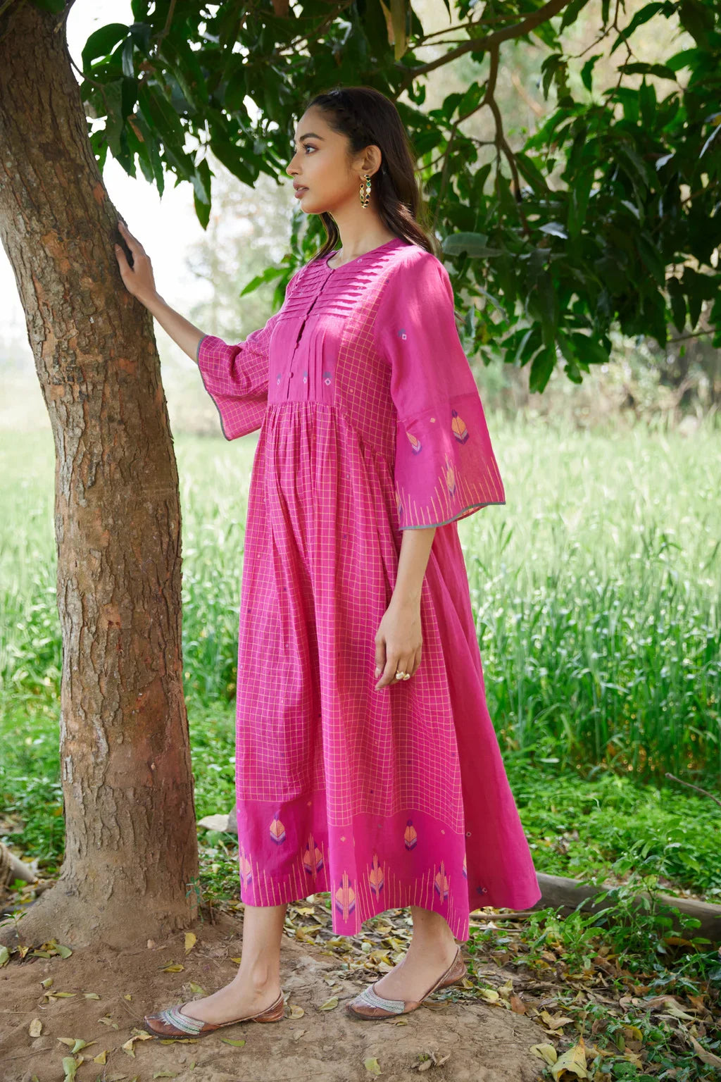 Sarron Anjoli Dress, pink cotton Jamdani dress with a checked weave, pintucks and fabric buttons.