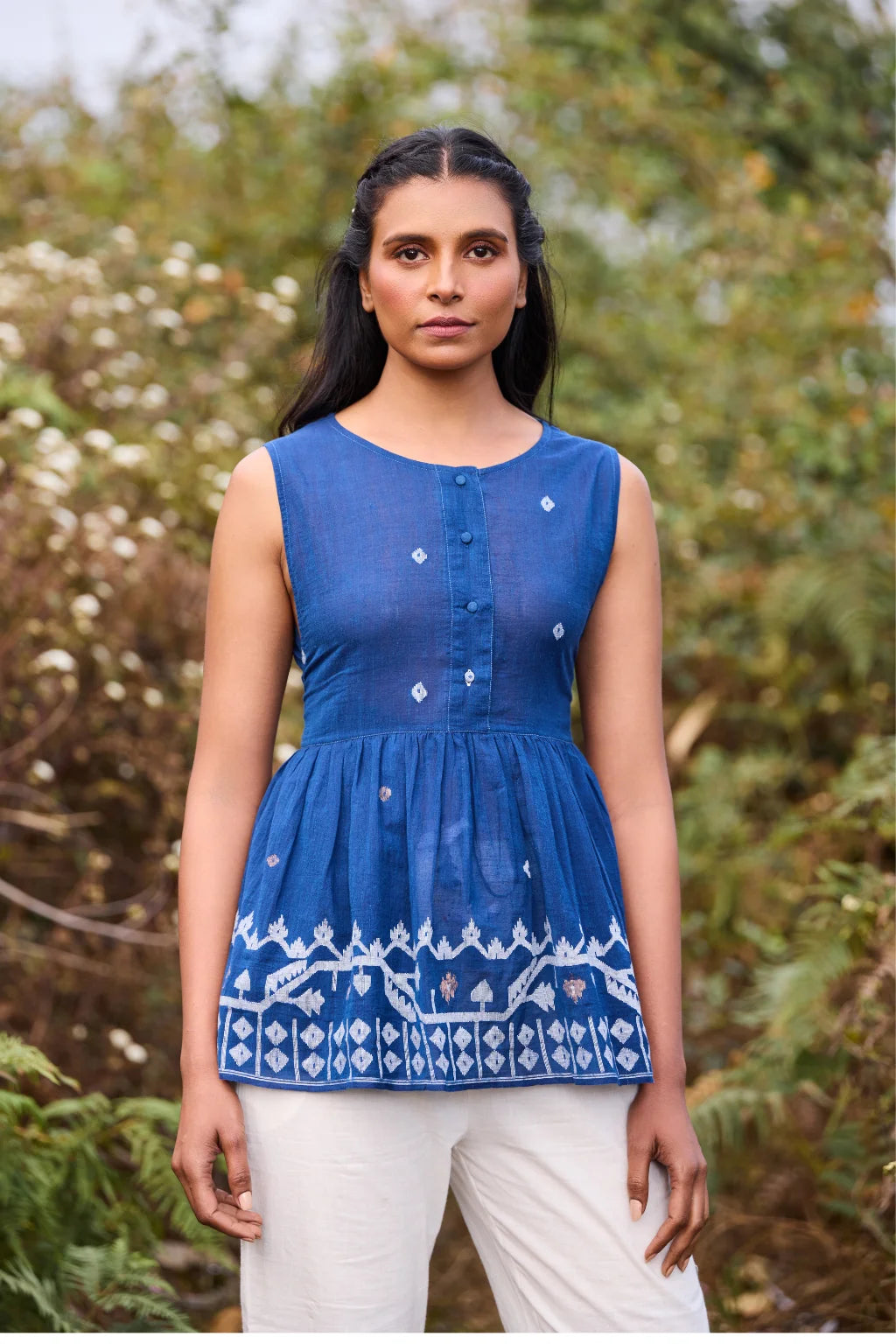 Sarron Aparajita Top, sleeveless blue cotton Jamdani top with tie-ups and a handcrafted bird tassel.