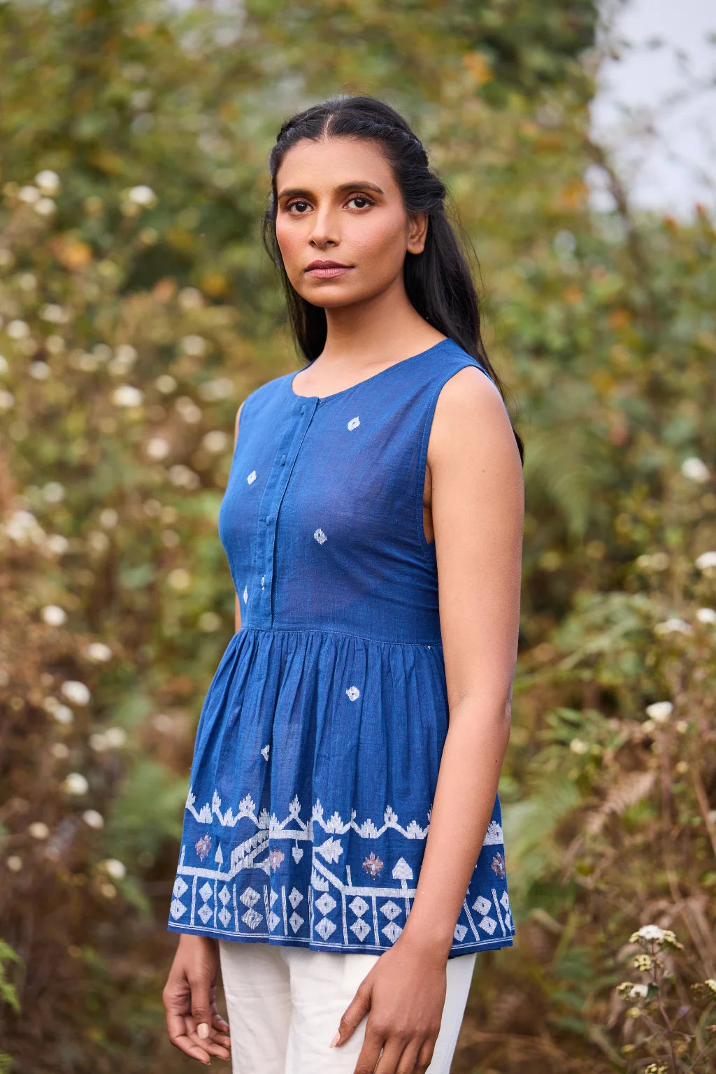 Sarron Aparajita Top, sleeveless blue cotton Jamdani top with tie-ups and a handcrafted bird tassel.
