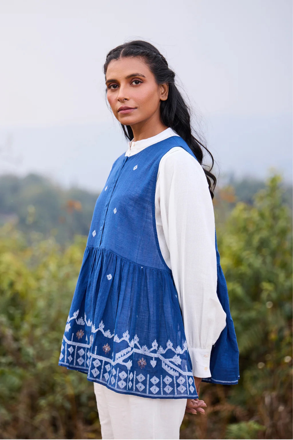 Sarron Aparajita Top, sleeveless blue cotton Jamdani top with tie-ups and a handcrafted bird tassel.