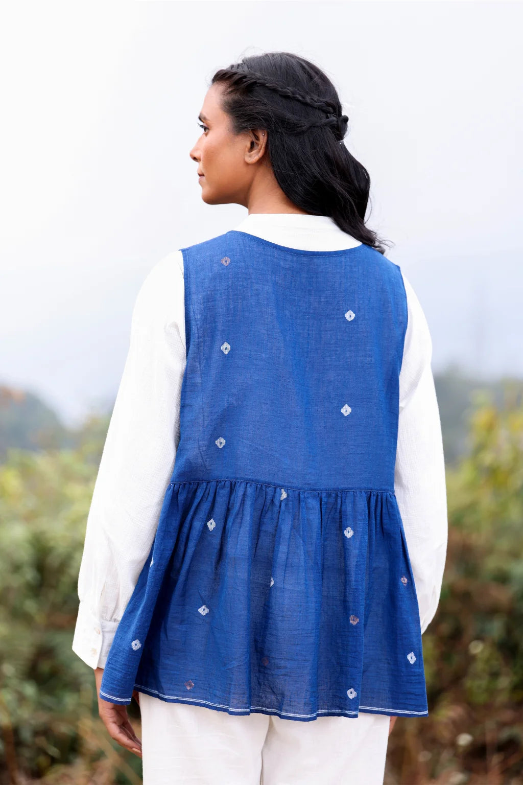 Sarron Aparajita Top, sleeveless blue cotton Jamdani top with tie-ups and a handcrafted bird tassel.