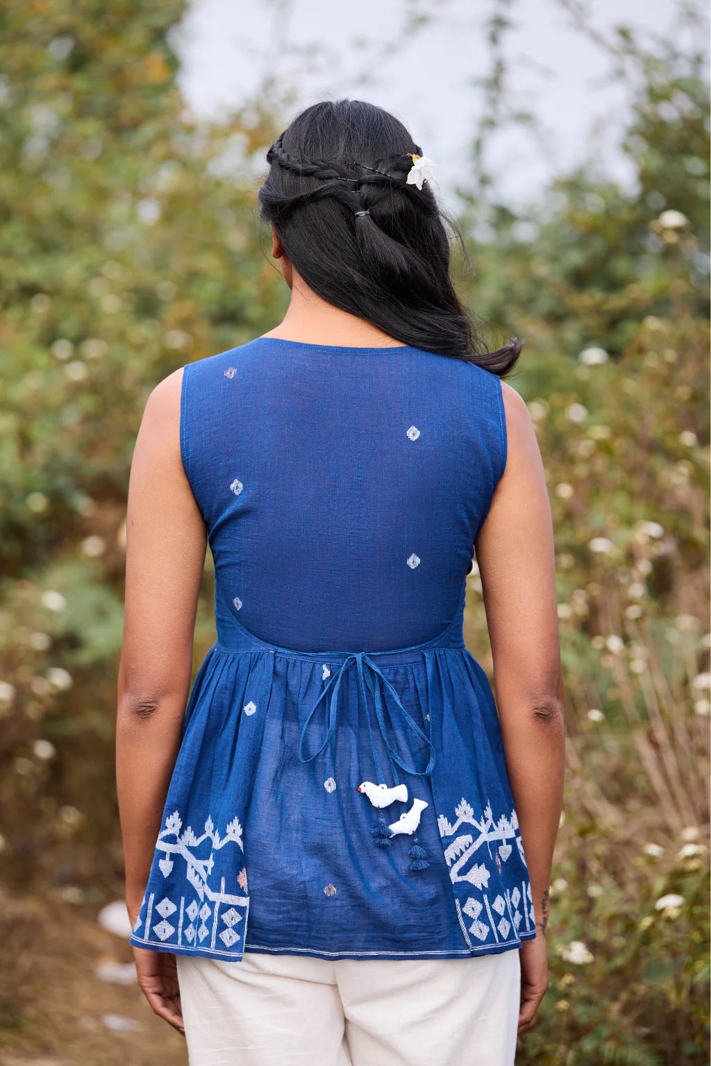Sarron Aparajita Top, sleeveless blue cotton Jamdani top with tie-ups and a handcrafted bird tassel.