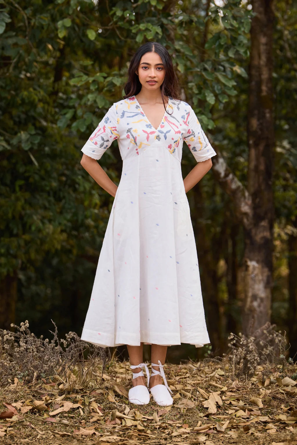Sarron Giribala Dress, white cotton Jamdani A-line dress with handwoven floral motifs and beaded neckline.