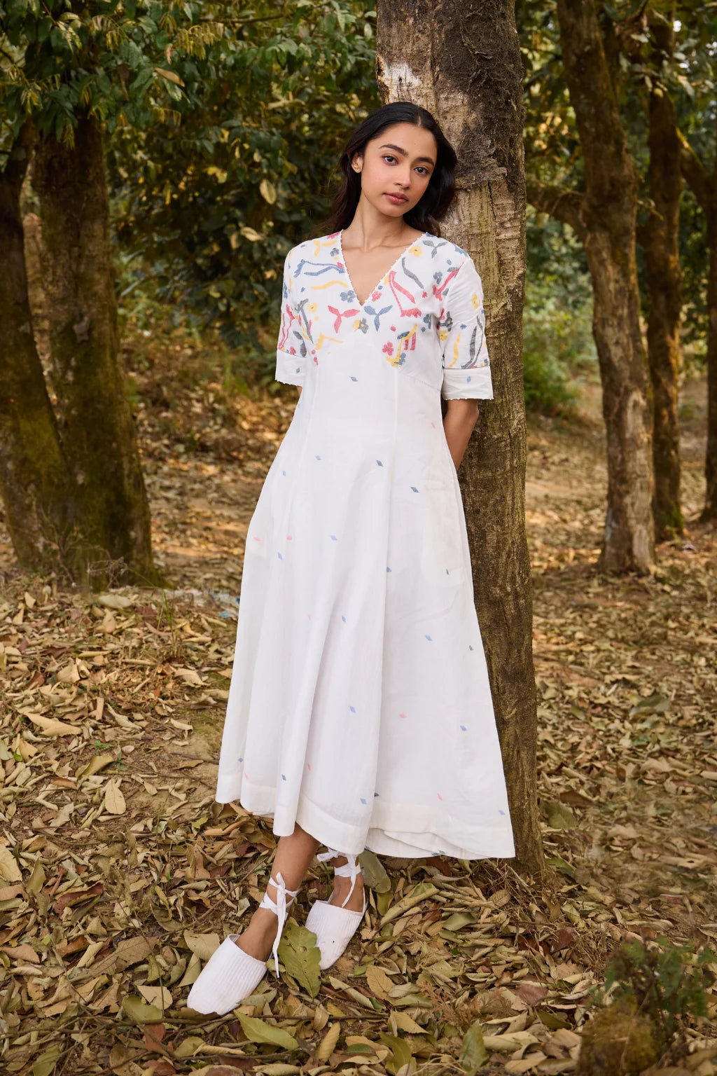 Sarron Giribala Dress, white cotton Jamdani A-line dress with handwoven floral motifs and beaded neckline.