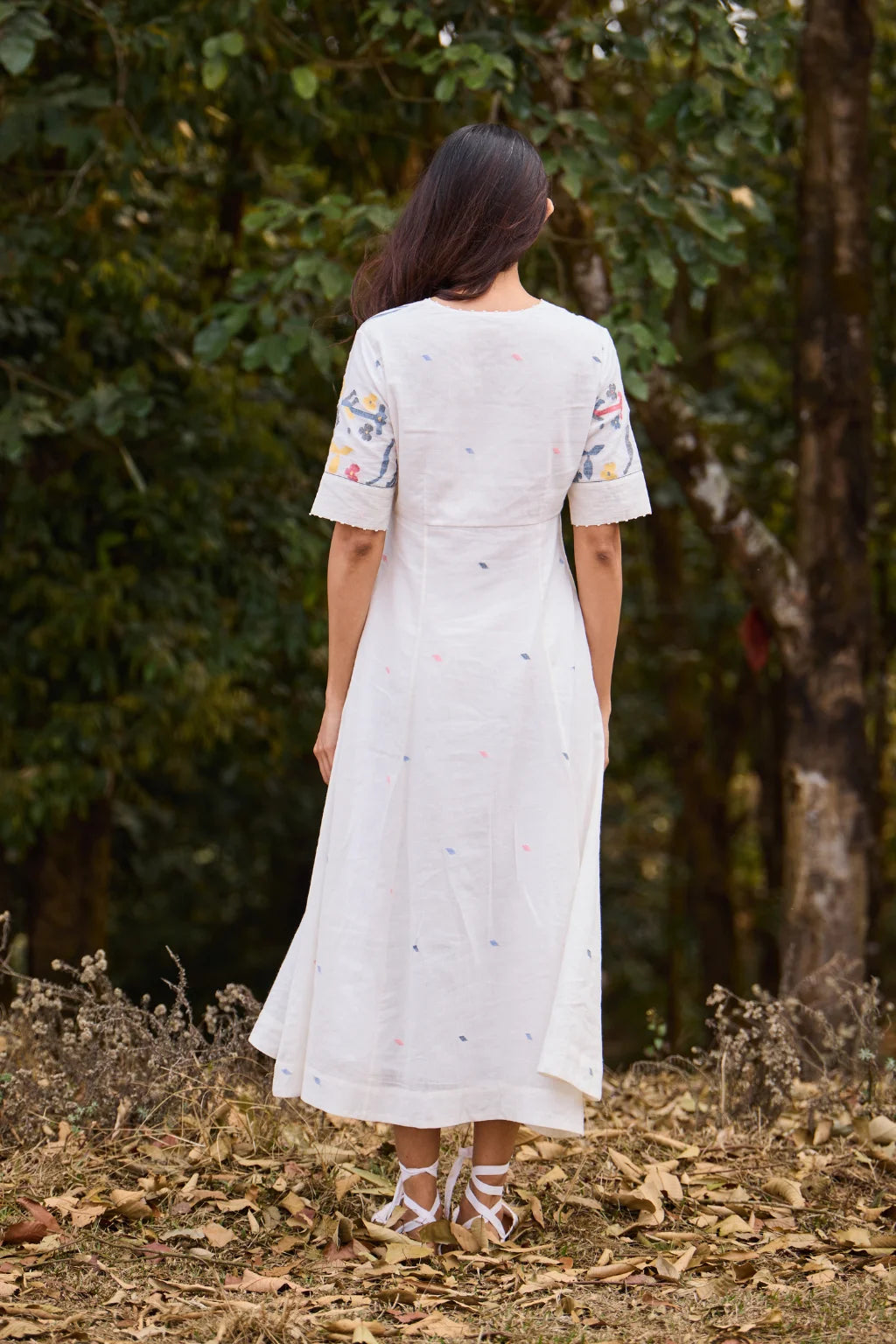 Sarron Giribala Dress, white cotton Jamdani A-line dress with handwoven floral motifs and beaded neckline.