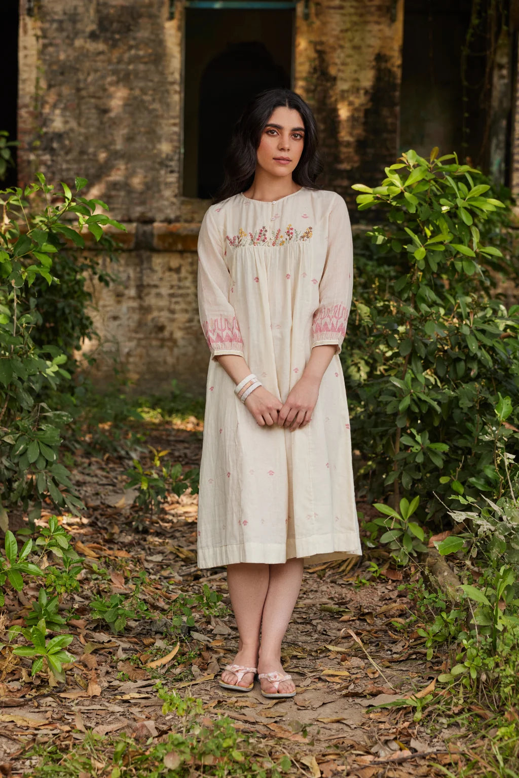 Sarron Khanak Dress, off-white cotton Jamdani dress with red and copper zari motifs and floral hand embroidery.