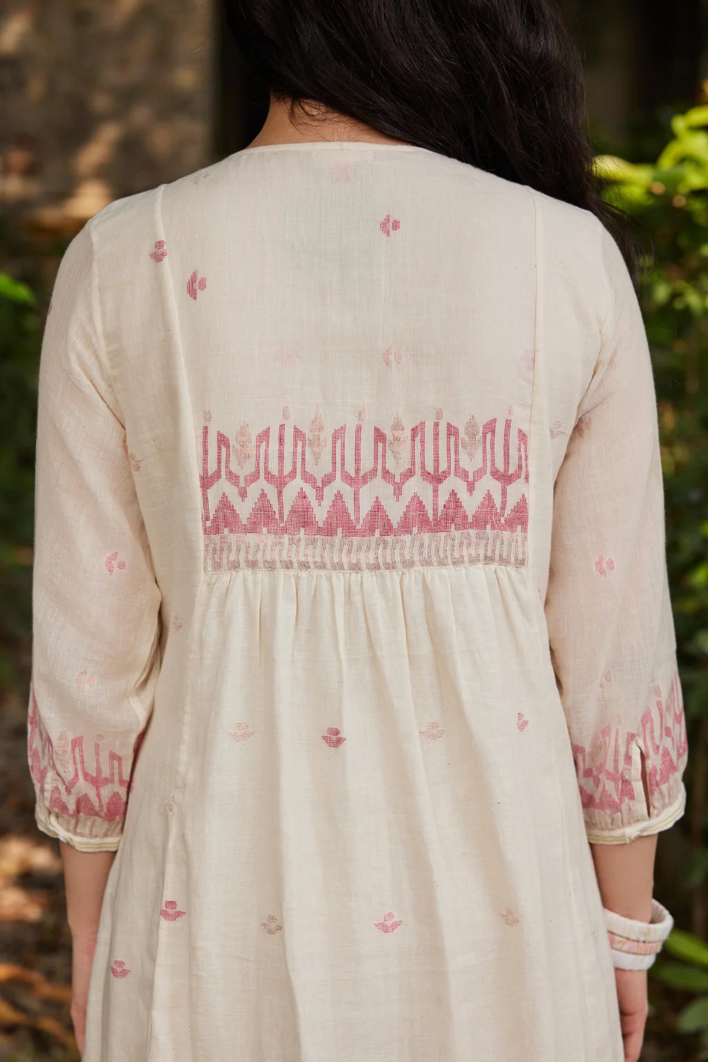 Sarron Khanak Dress, off-white cotton Jamdani dress with red and copper zari motifs and floral hand embroidery.