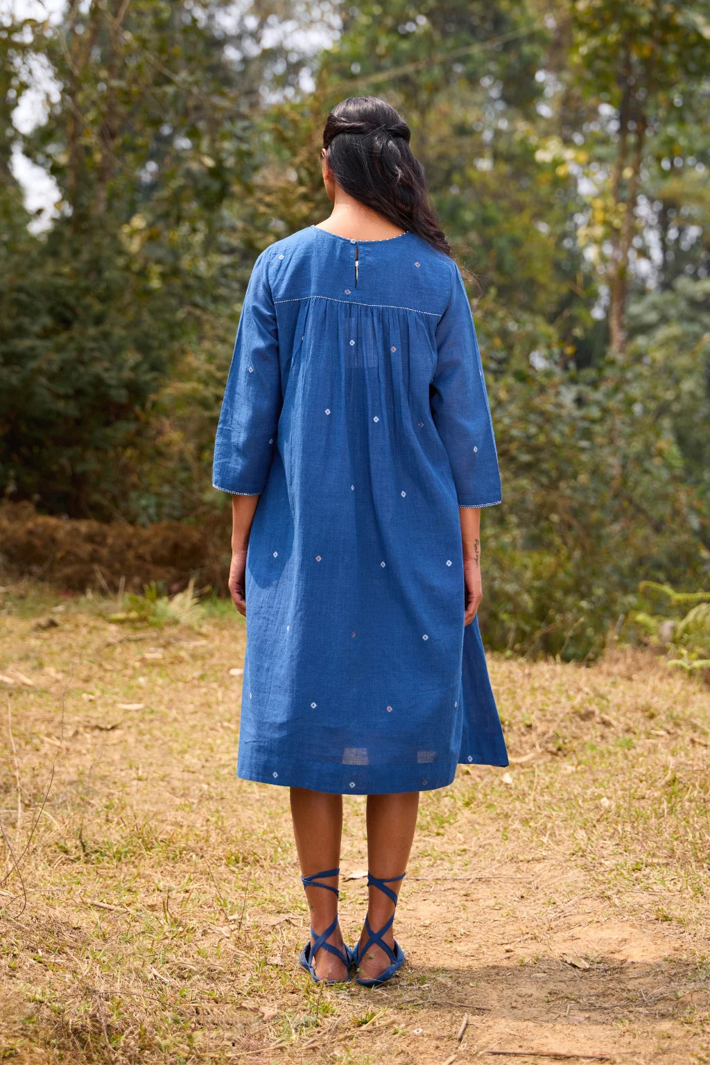 Sarron Neelpadma Dress, deep indigo cotton Jamdani flare dress with geometric hem motifs and pintucks.
