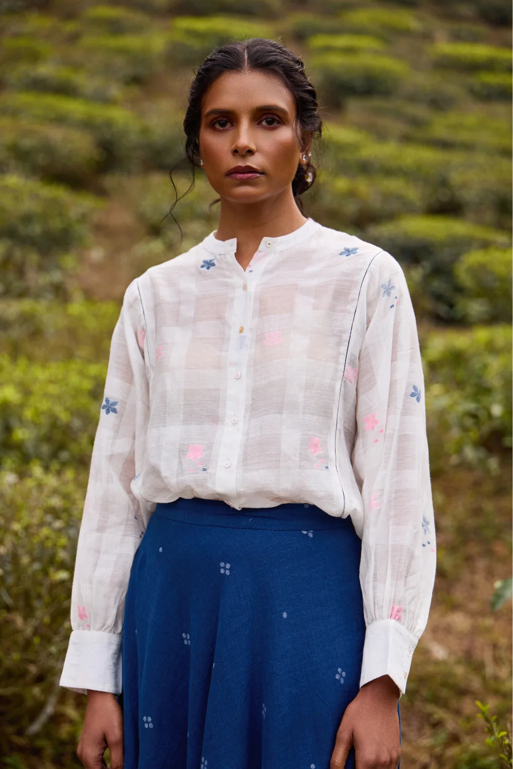 Sarron Neeltara Shirt, loose white silk-cotton Jamdani shirt with handwoven blue and pink flower motifs.