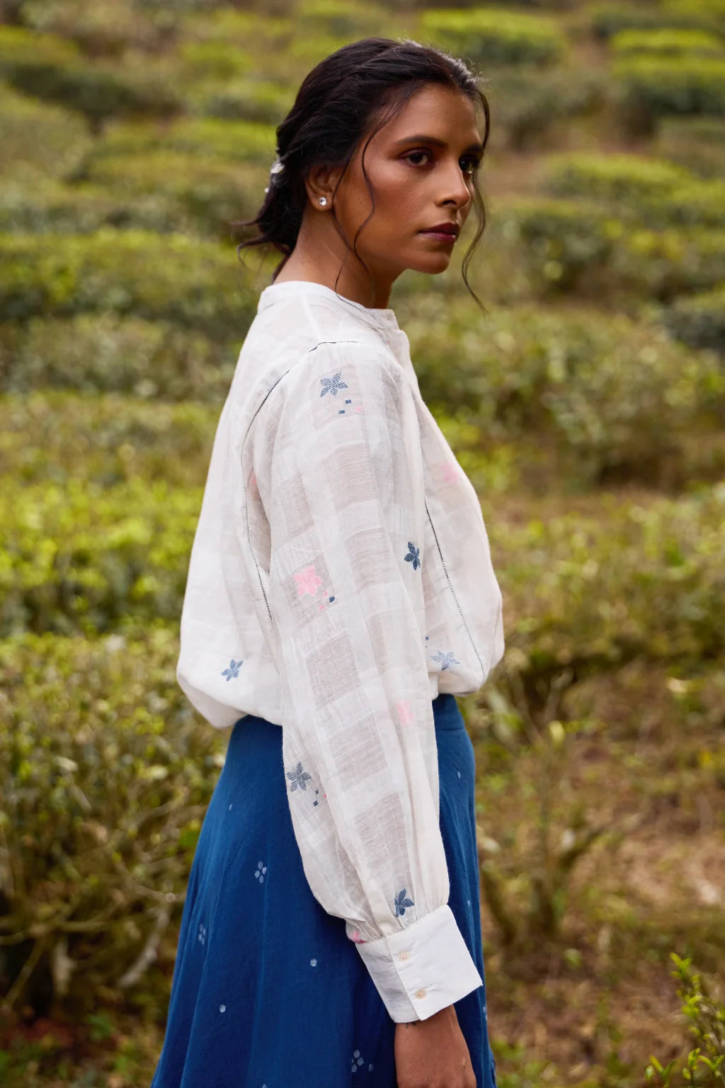 Sarron Neeltara Shirt, loose white silk-cotton Jamdani shirt with handwoven blue and pink flower motifs.
