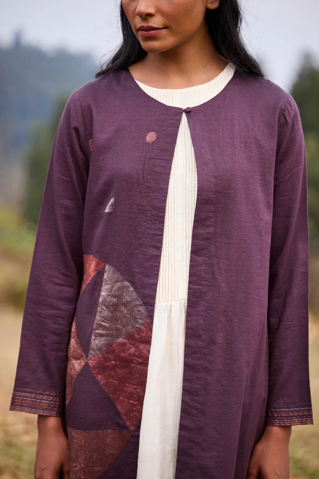 Sarron Parijat Set, ivory silk dress with hand-painted motifs and a plum silk-cotton Jamdani overlay.