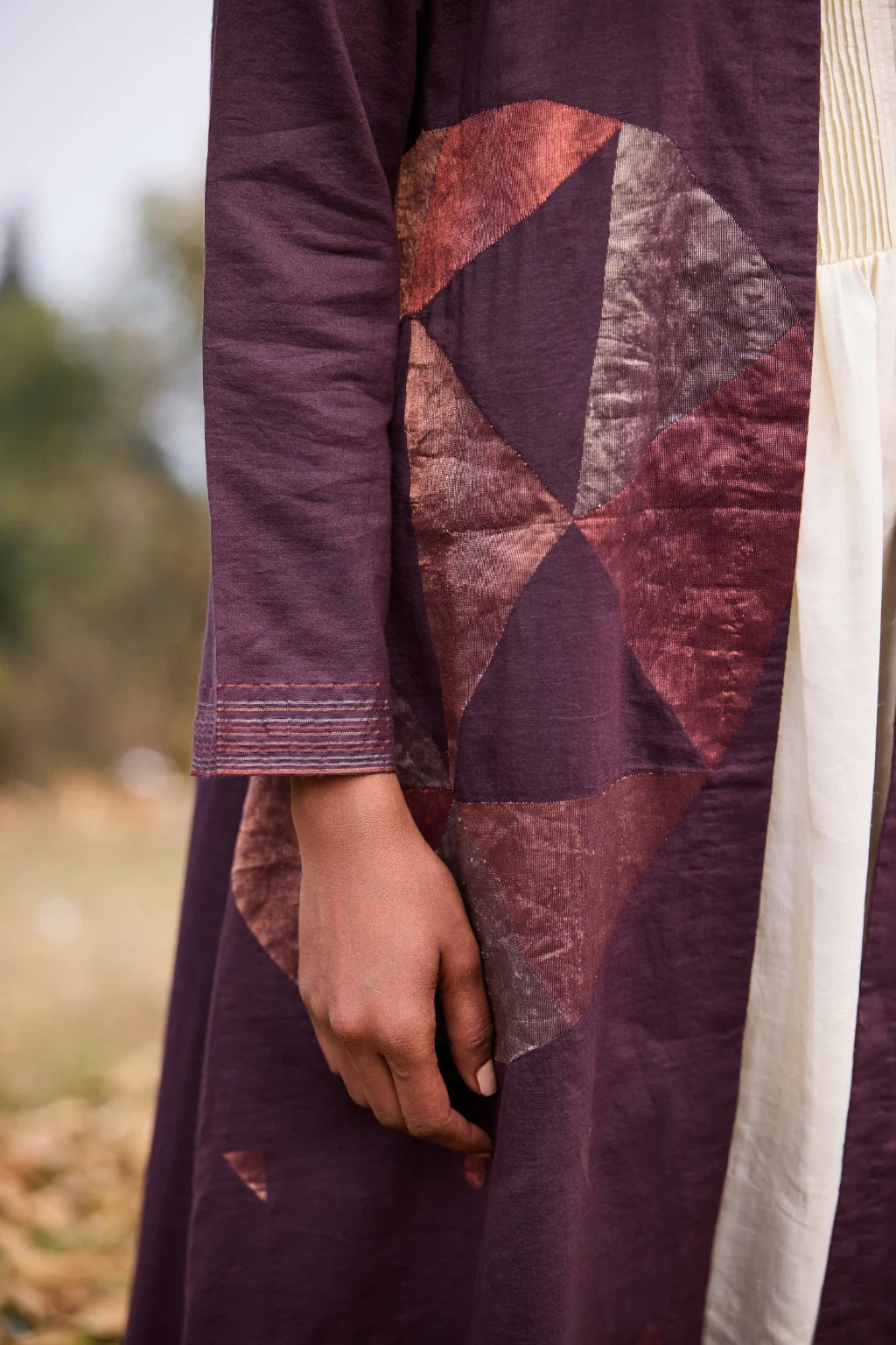 Sarron Parijat Set, ivory silk dress with hand-painted motifs and a plum silk-cotton Jamdani overlay.