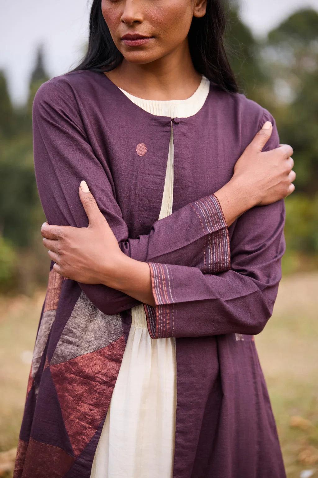 Sarron Parijat Set, ivory silk dress with hand-painted motifs and a plum silk-cotton Jamdani overlay.