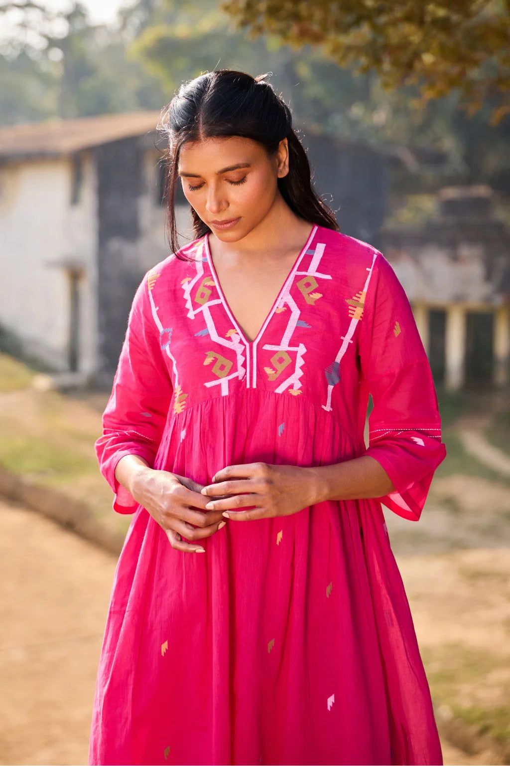Sarron Raktima Dress, pink cotton Jamdani dress with a large geometric yoke motif and Kantha-worked sleeves.