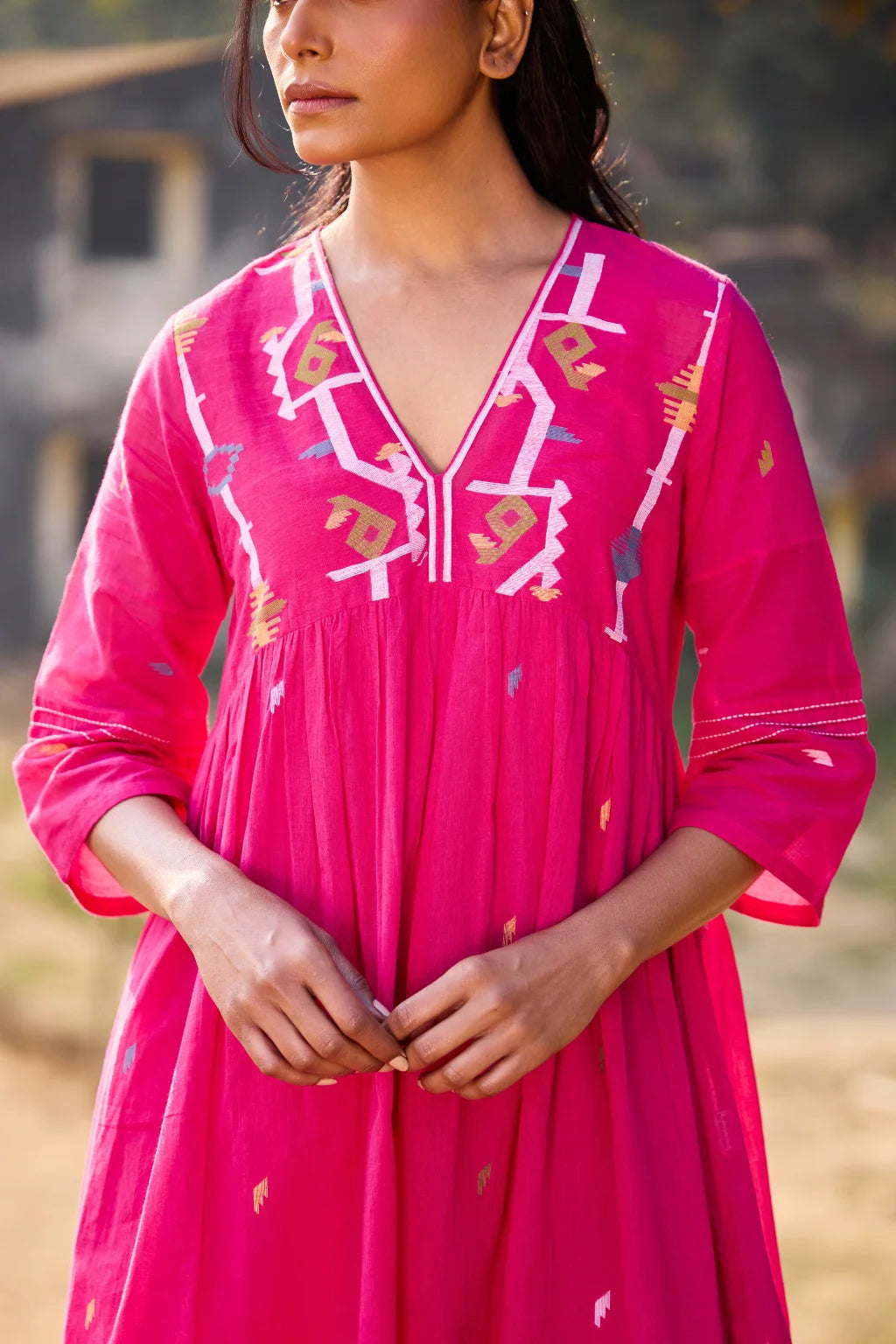 Sarron Raktima Dress, pink cotton Jamdani dress with a large geometric yoke motif and Kantha-worked sleeves.