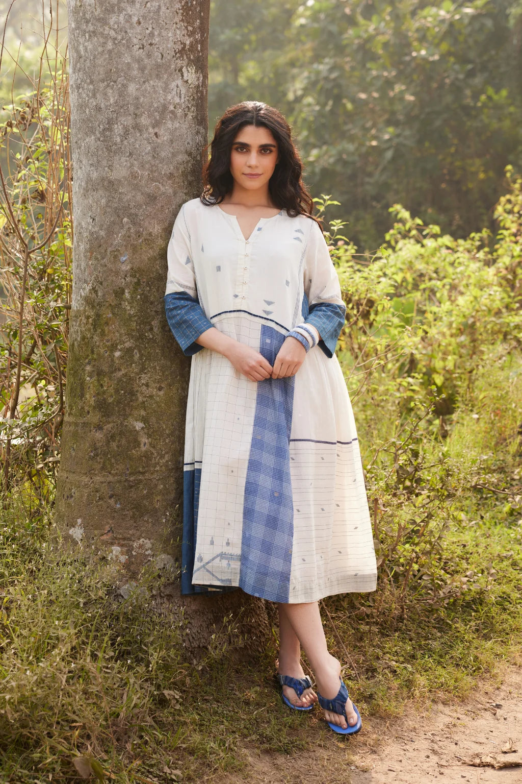 Sarron Sevina Dress, white and blue patchwork cotton Jamdani dress with zari-check panels and fabric buttons.