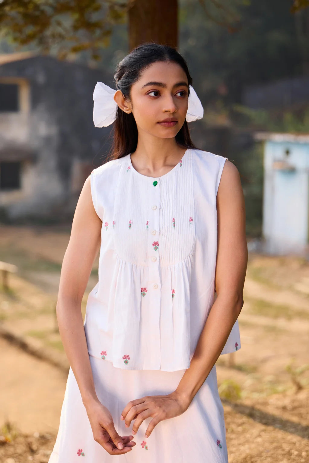 Sarron Shiuli Top, sleeveless white cotton Jamdani top with handwoven floral motifs and front pintucks.