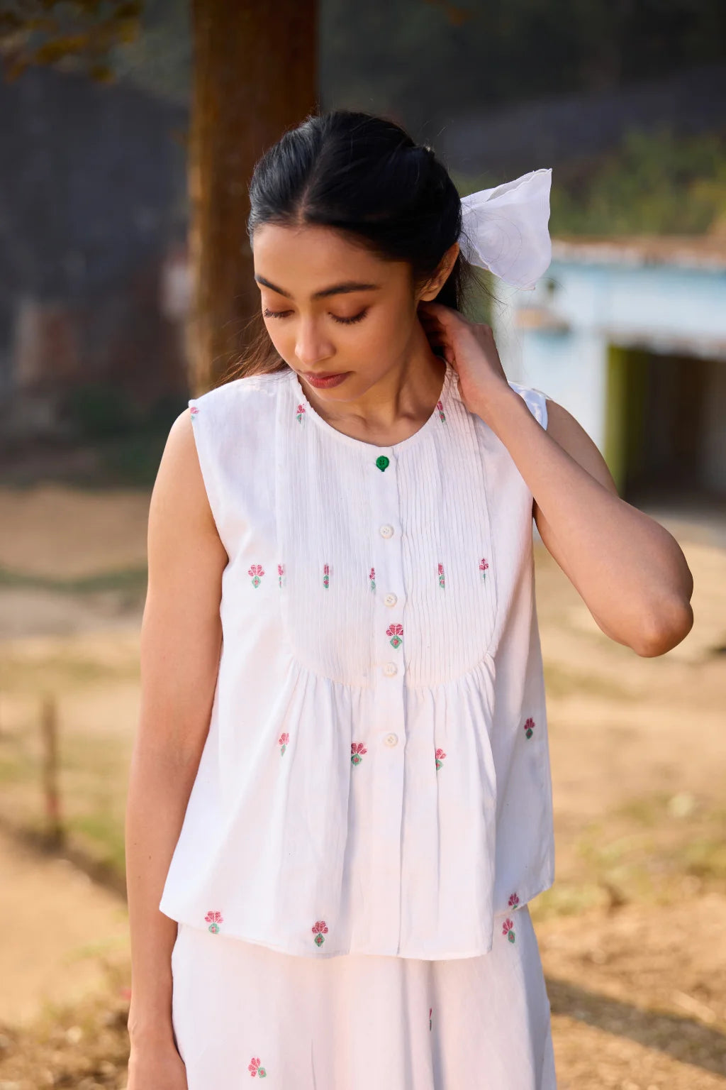 Sarron Shiuli Top, sleeveless white cotton Jamdani top with handwoven floral motifs and front pintucks.