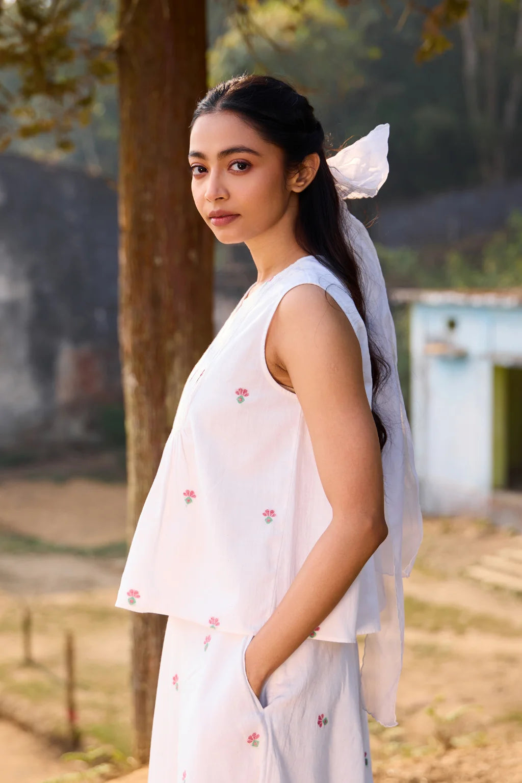 Sarron Shiuli Top, sleeveless white cotton Jamdani top with handwoven floral motifs and front pintucks.
