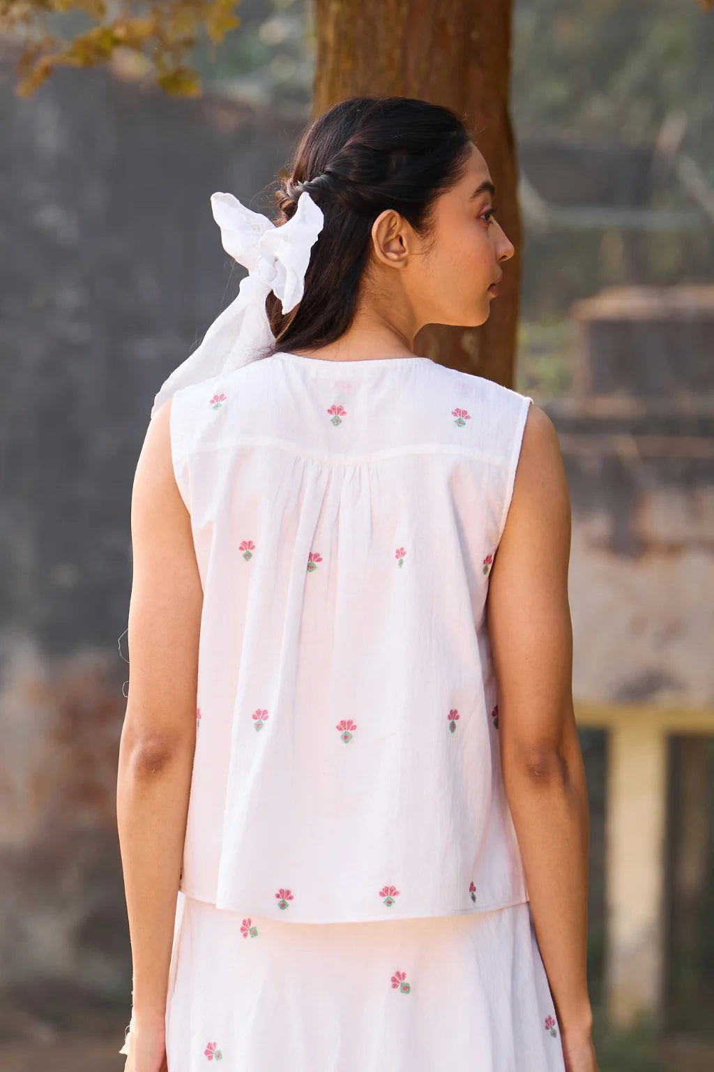 Sarron Shiuli Top, sleeveless white cotton Jamdani top with handwoven floral motifs and front pintucks.