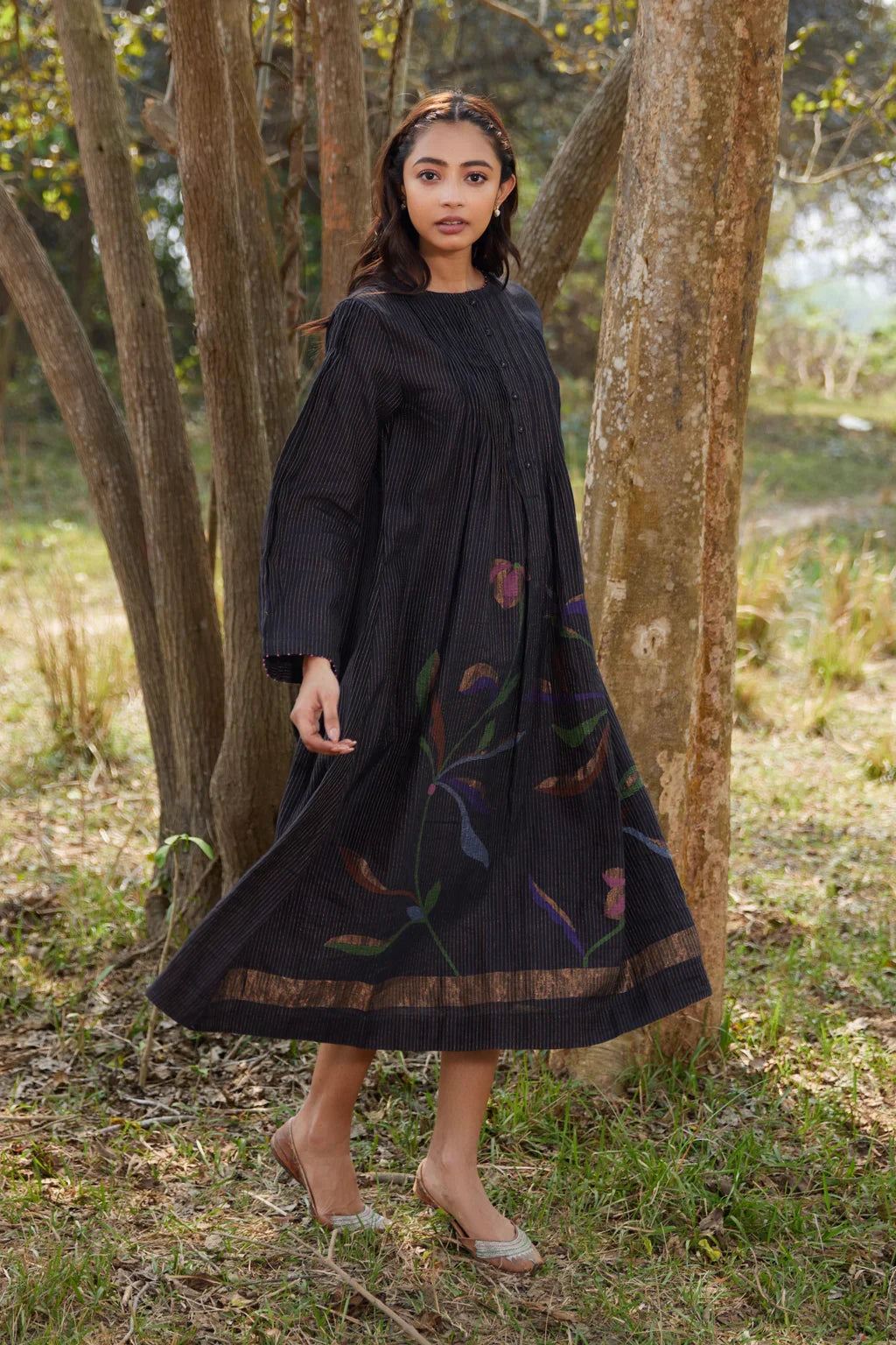 Sarron Sumi Dress, black silk-cotton Jamdani dress with golden stripes and scattered floral motifs.