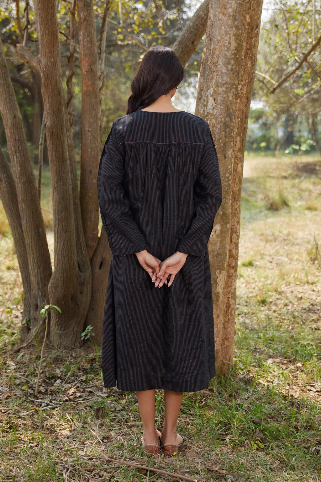 Sarron Sumi Dress, black silk-cotton Jamdani dress with golden stripes and scattered floral motifs.