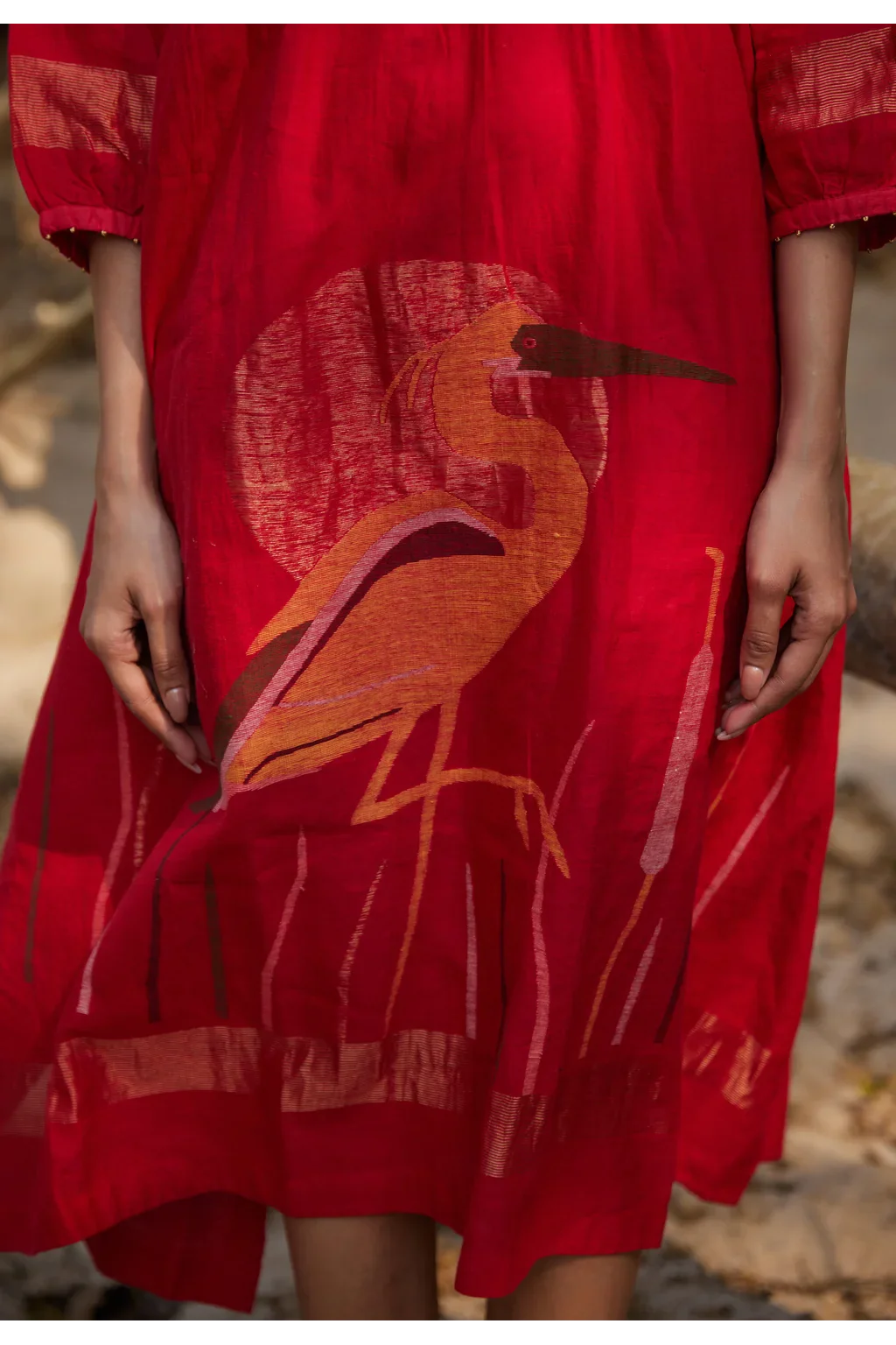 Sarron Susmita Dress, red silk-cotton Jamdani dress with a handwoven flamingo motif and a flared hem.